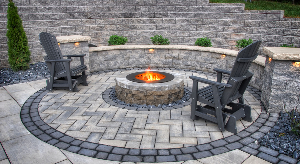 Stone fire pit patio with Adirondack chairs